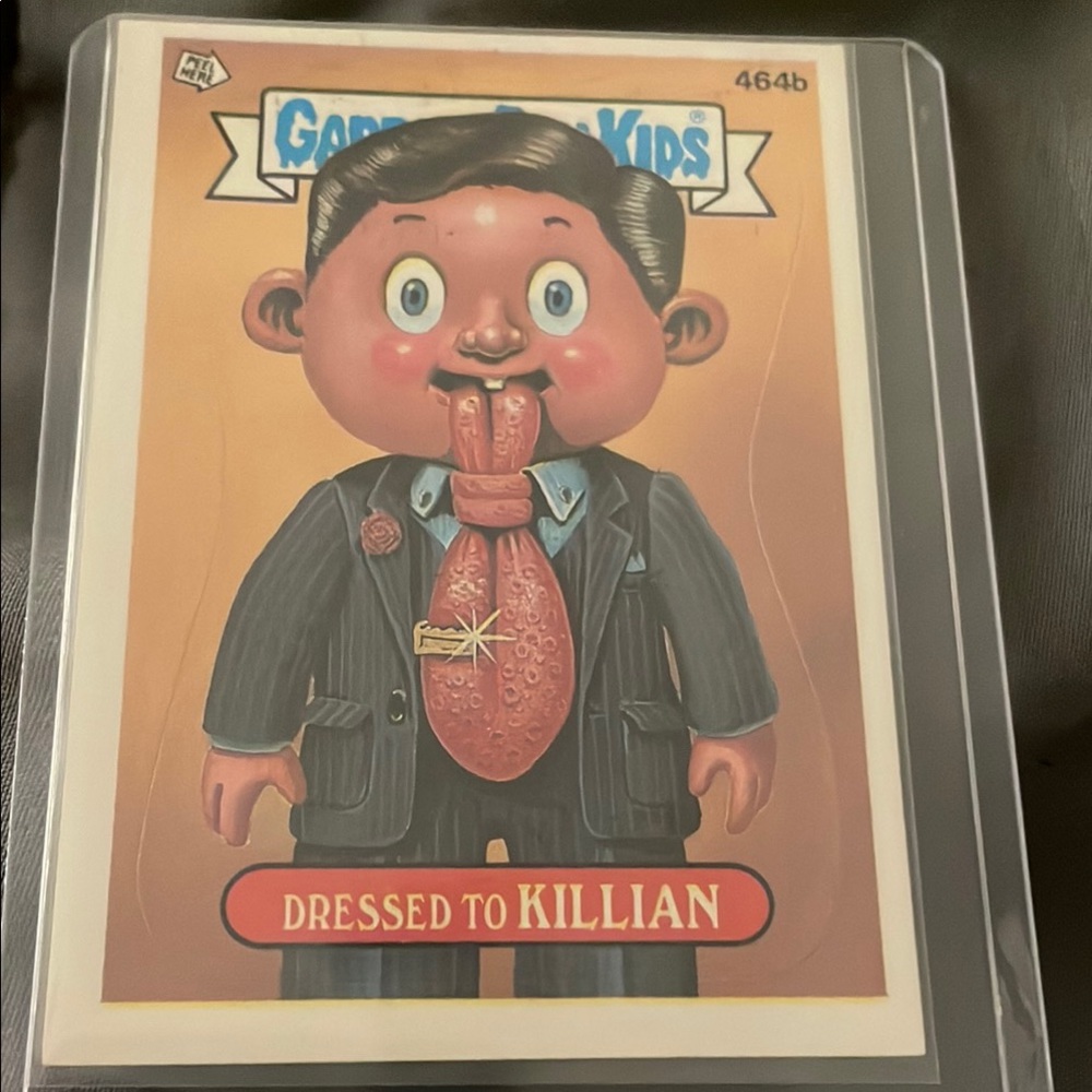Topps Black and Brown Trading Card with Cartoon Character dressed to killian